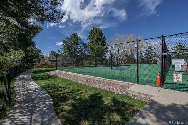 a view of a garden with lawn chairs and a fire pit