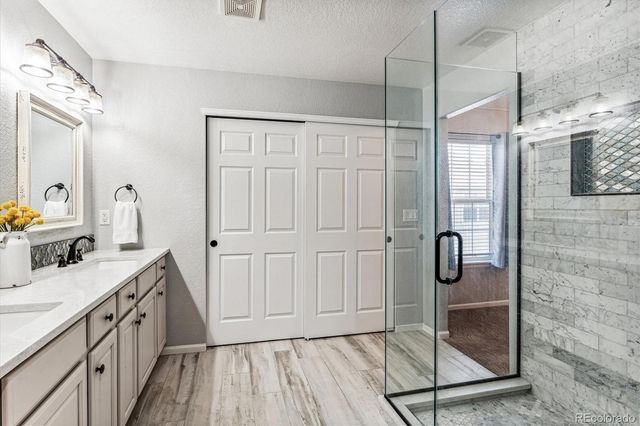 a bathroom with a sink a mirror and shower