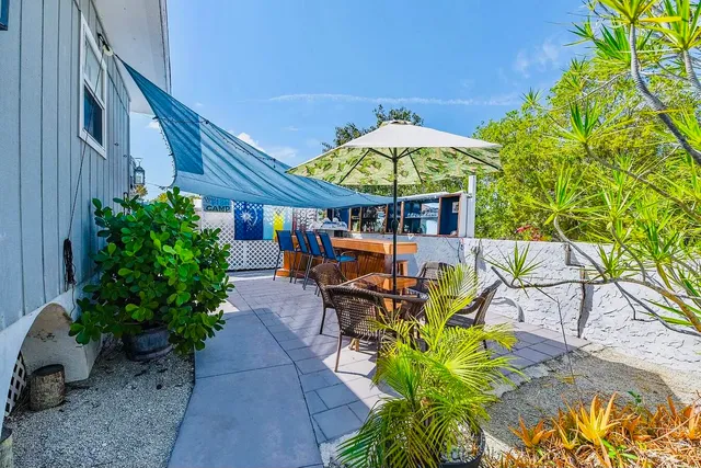 a view of a table and chairs under an umbrella