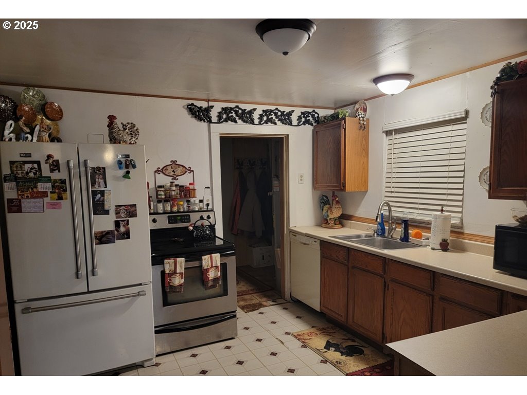 309 A Avenue Seneca, OR 97873 - Photo 14 of 35 a kitchen with stainless steel appliances kitchen island granite countertop a refrigerator and a sink