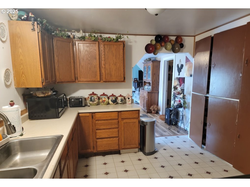 309 A Avenue Seneca, OR 97873 - Photo 15 of 35 a kitchen with stainless steel appliances a sink stove and refrigerator