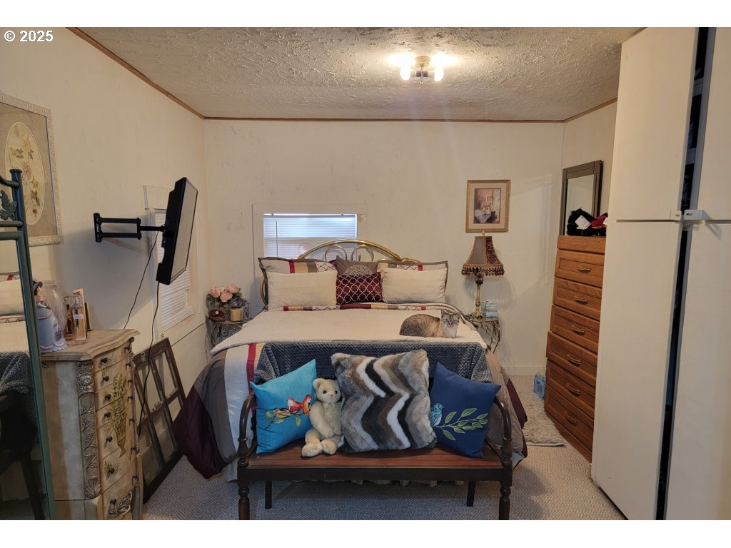 309 A Avenue Seneca, OR 97873 - Photo 16 of 35 a bedroom with furniture and a wooden floor