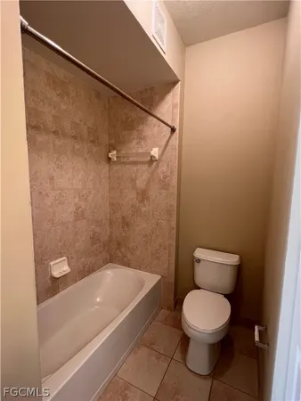 a bathroom with a toilet a sink and shower