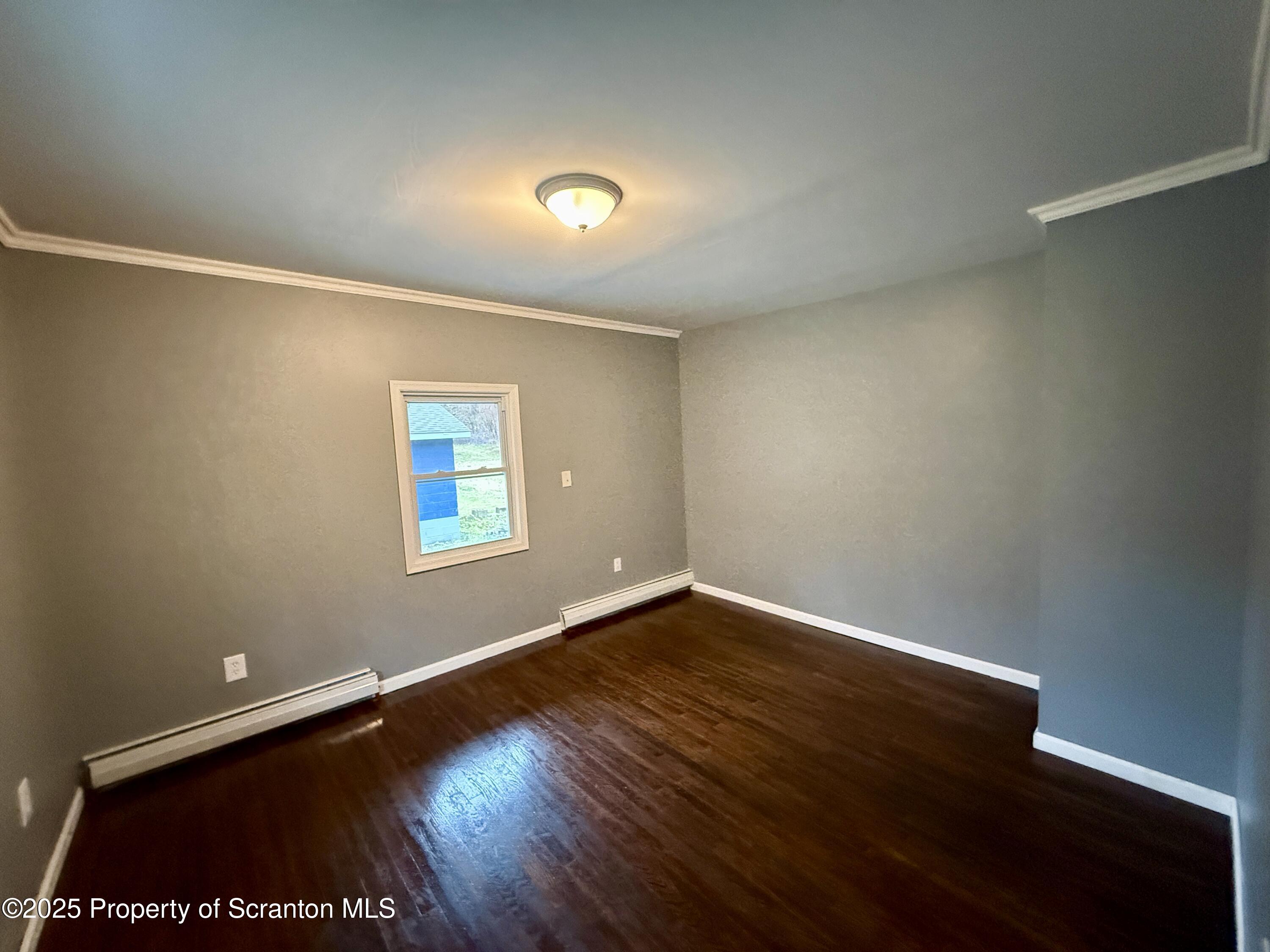 112 Mowry Road Meshoppen, PA 18630 - Photo 15 of 30 an empty room with wooden floor and windows