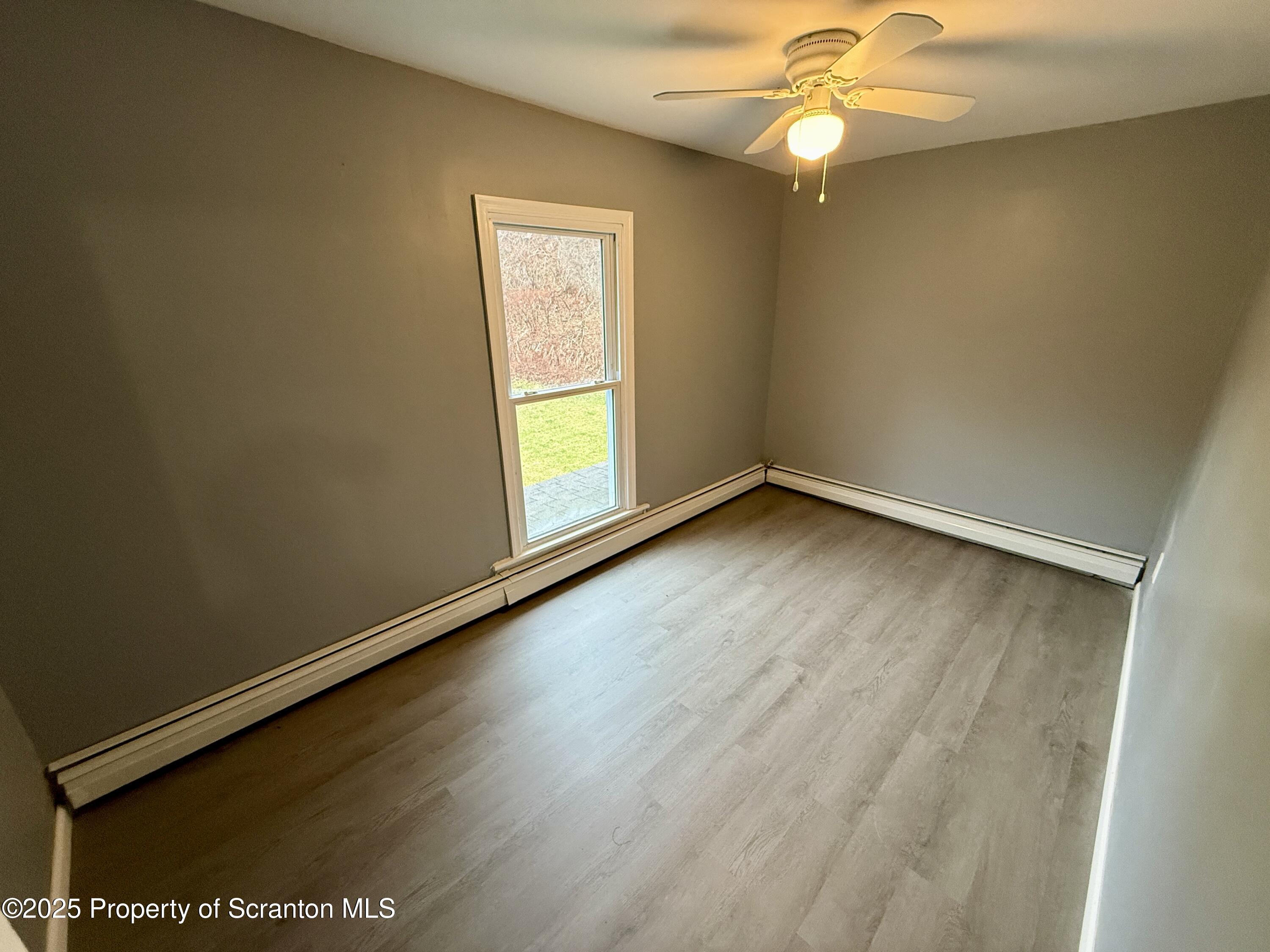 112 Mowry Road Meshoppen, PA 18630 - Photo 19 of 30 an empty room with a window and ceiling fan