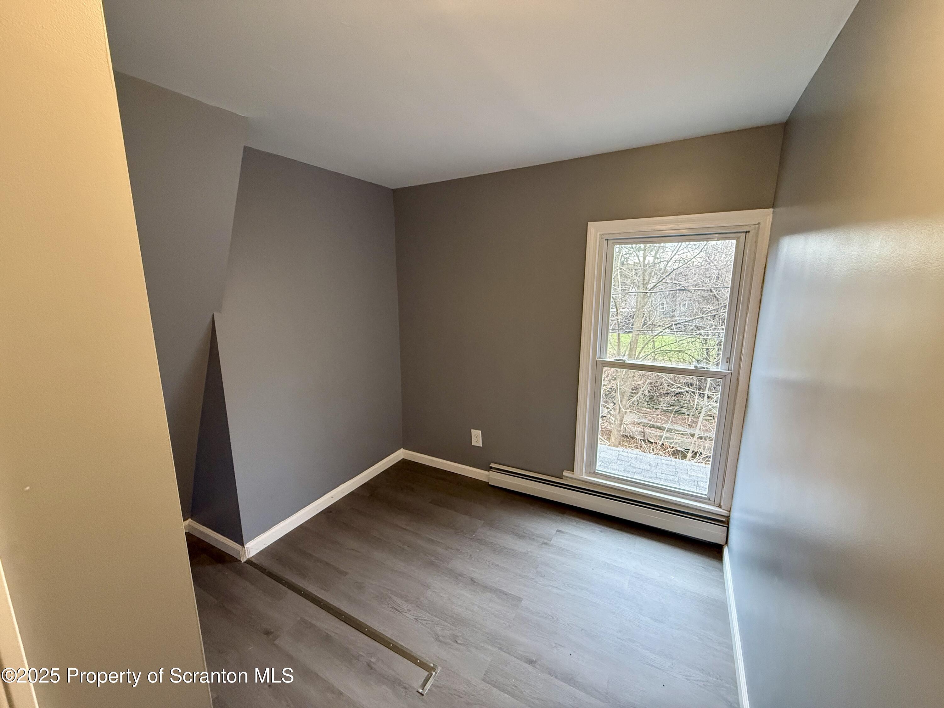 112 Mowry Road Meshoppen, PA 18630 - Photo 22 of 30 an empty room with wooden floor and windows