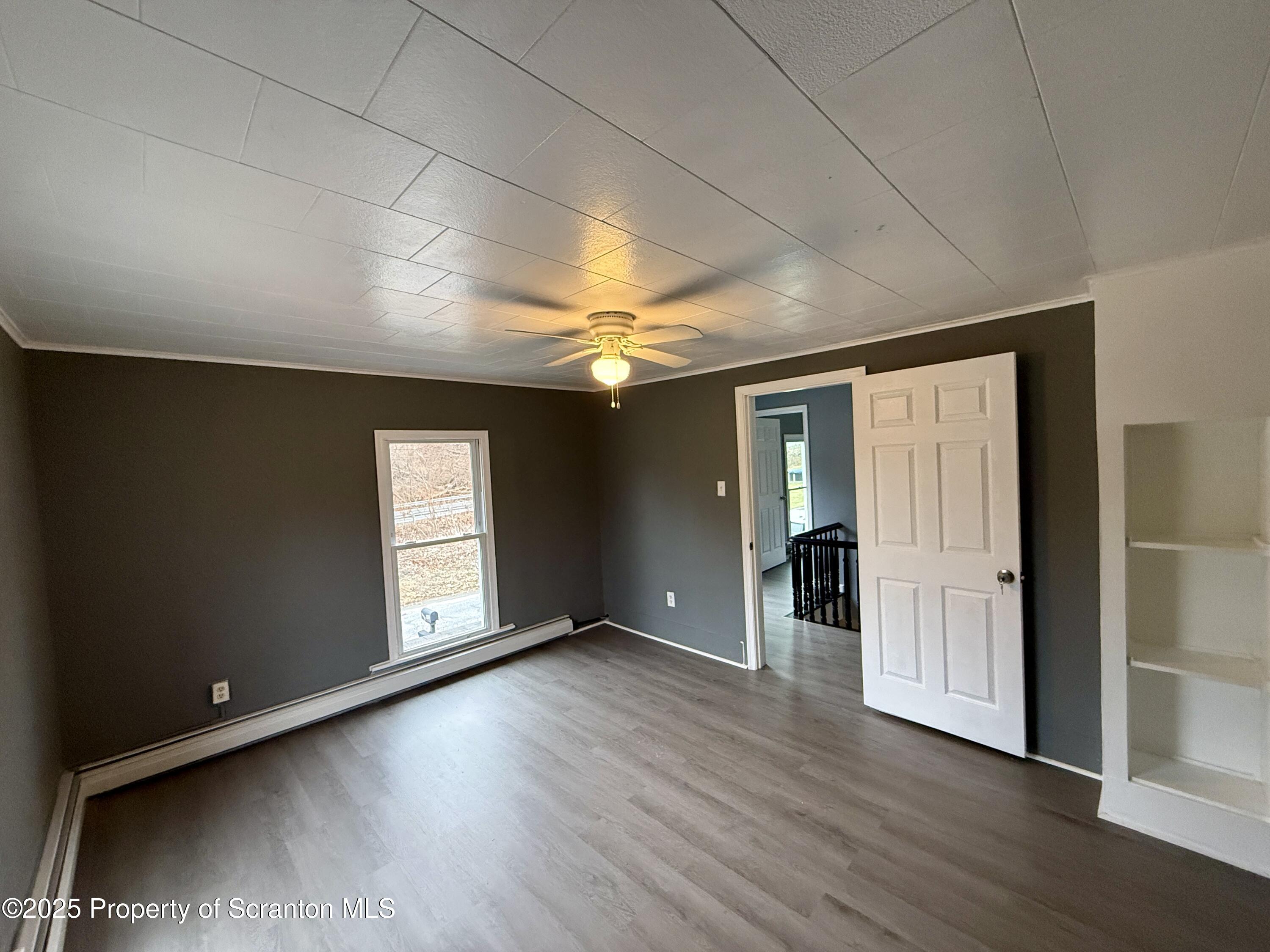 112 Mowry Road Meshoppen, PA 18630 - Photo 25 of 30 an empty room with wooden floor and windows
