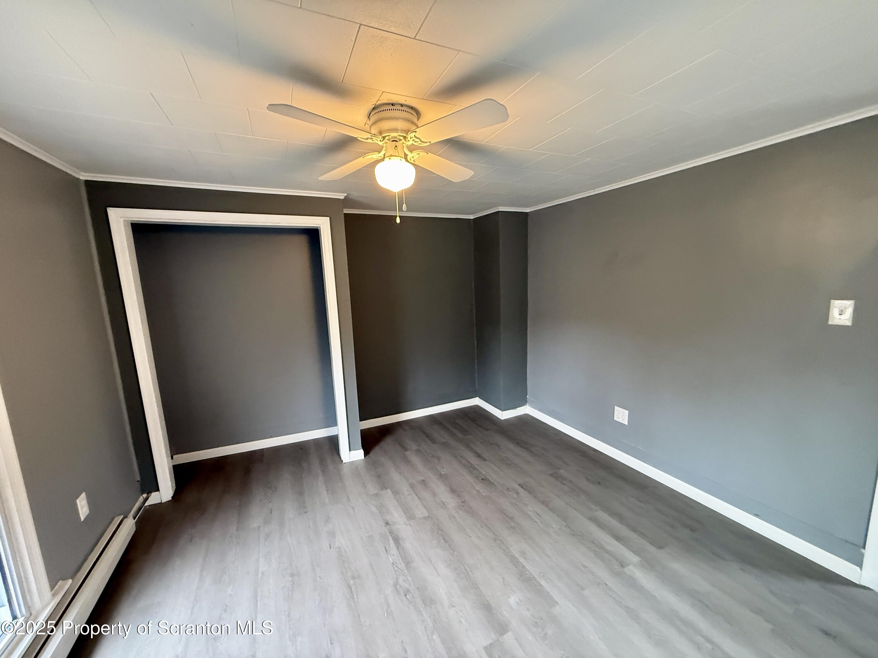 112 Mowry Road Meshoppen, PA 18630 - Photo 27 of 30 an empty room with wooden floor fan and windows