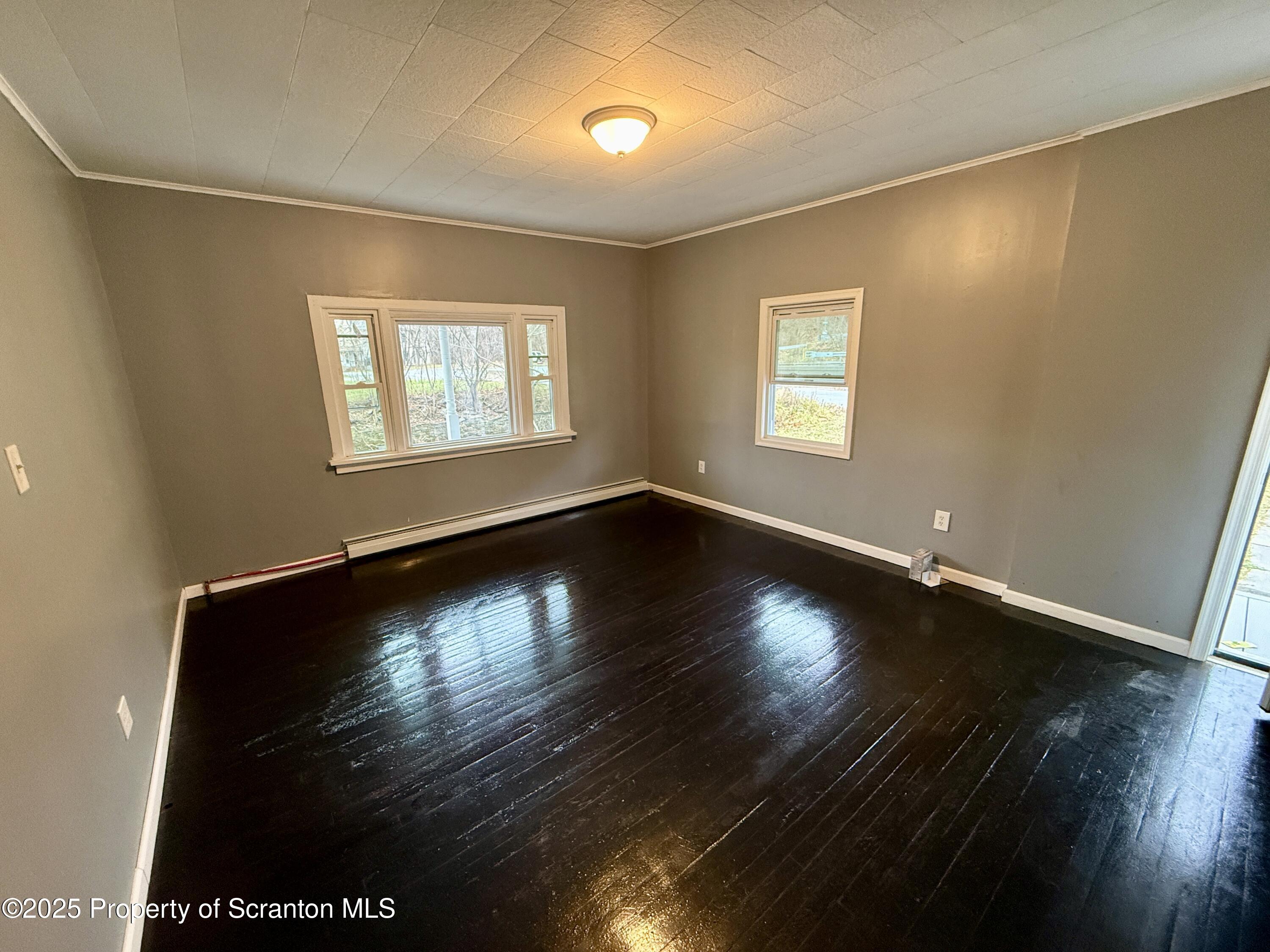 112 Mowry Road Meshoppen, PA 18630 - Photo 7 of 30 an empty room with wooden floor and windows