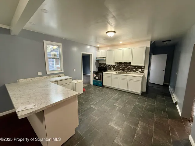 a kitchen with a sink stove and refrigerator