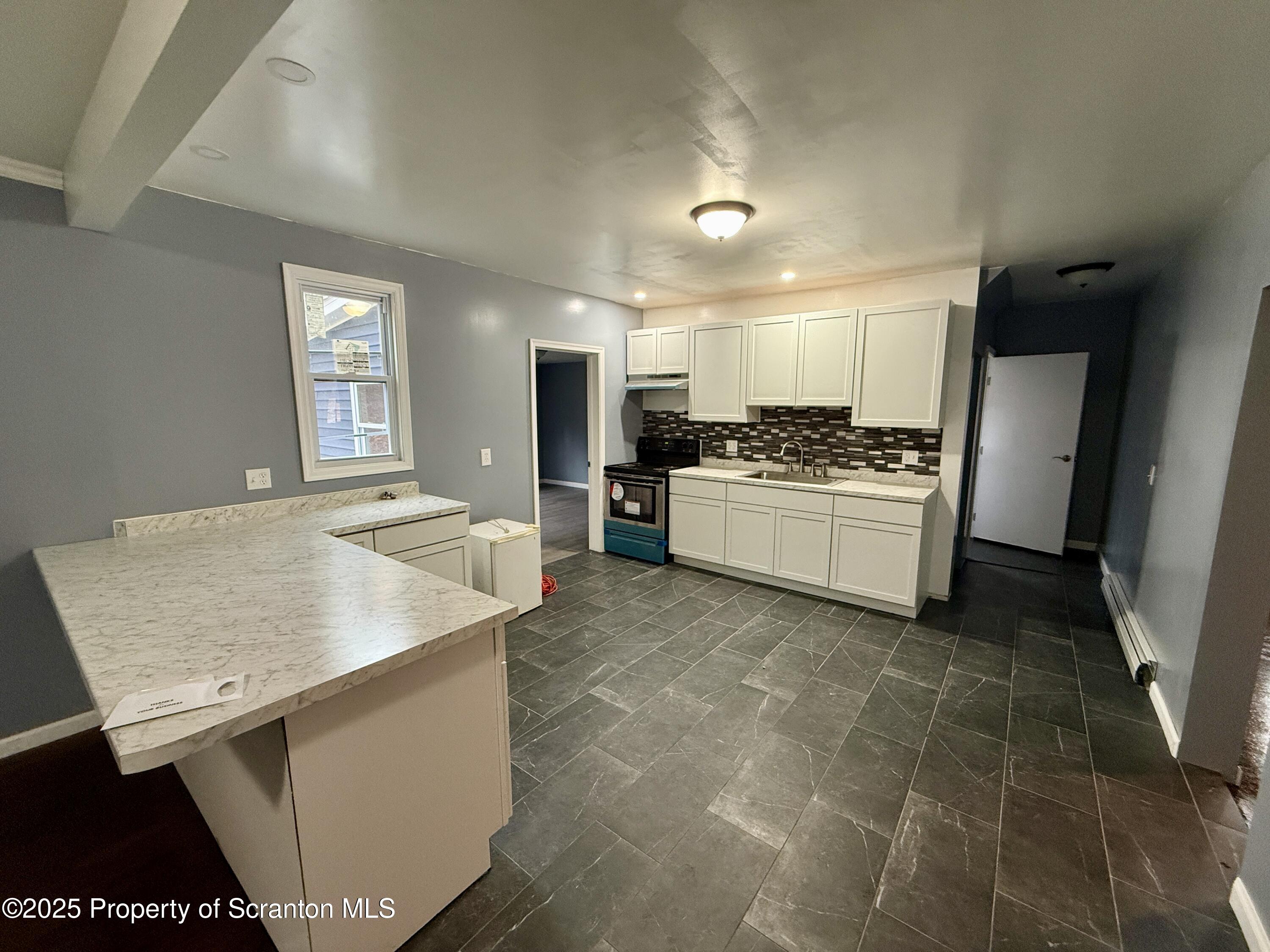 112 Mowry Road Meshoppen, PA 18630 - Photo 9 of 30 a kitchen with a sink stove and refrigerator