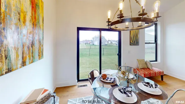 a kitchen with stainless steel appliances kitchen island granite countertop a refrigerator a stove a kitchen island a dining table and chairs with wooden floor