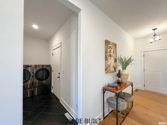a kitchen with kitchen island a counter top space cabinets and stainless steel appliances