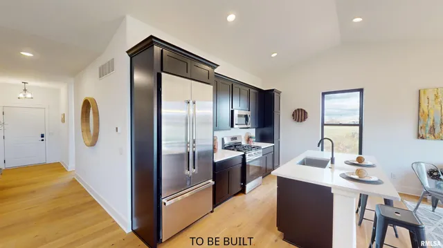 a kitchen with stainless steel appliances a refrigerator and a sink