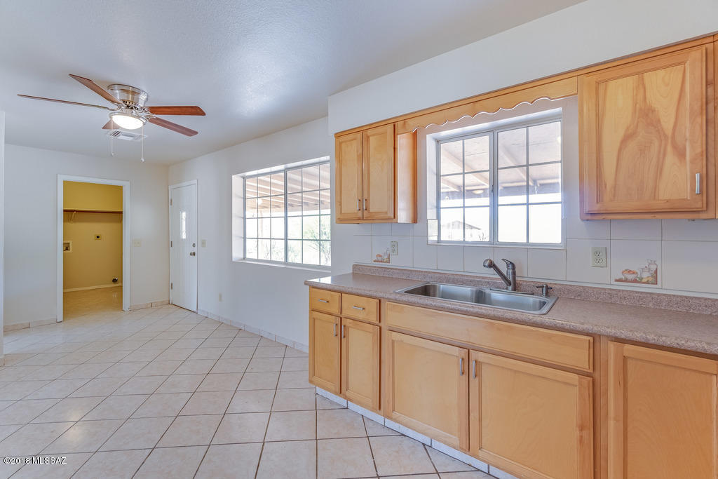 549 Valdez Court Rio Rico, AZ 85648 - Photo 13 of 27 a kitchen with a sink a window and cabinets