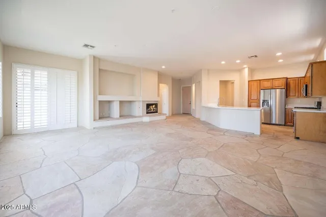 a view of an empty room with a kitchen