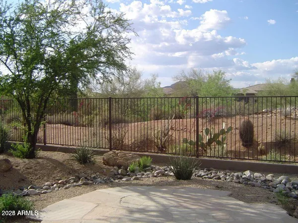 a view of a street with a wooden fence