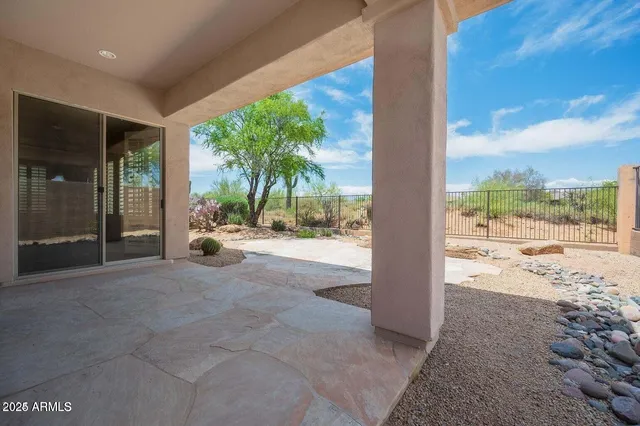 a view of a porch with a floor to ceiling window next to a yard