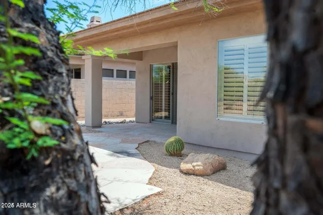 a view of a porch with a floor to ceiling window next to a yard