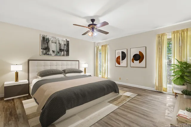 a bedroom with a large bed and a chandelier