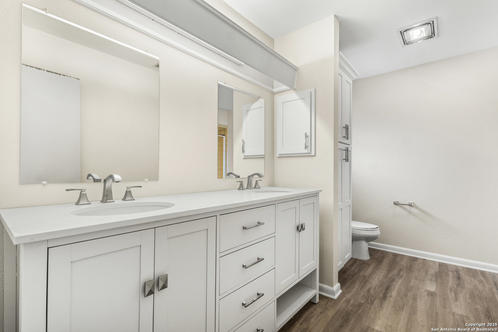 6041 Trone Trail Leon Valley, TX 78238 - Photo 18 of 30 a bathroom with a double vanity sink toilet and a mirror