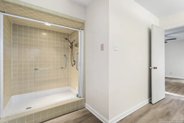 a bathroom with a bathtub and a shower