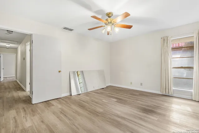 wooden floor in an empty room with a window