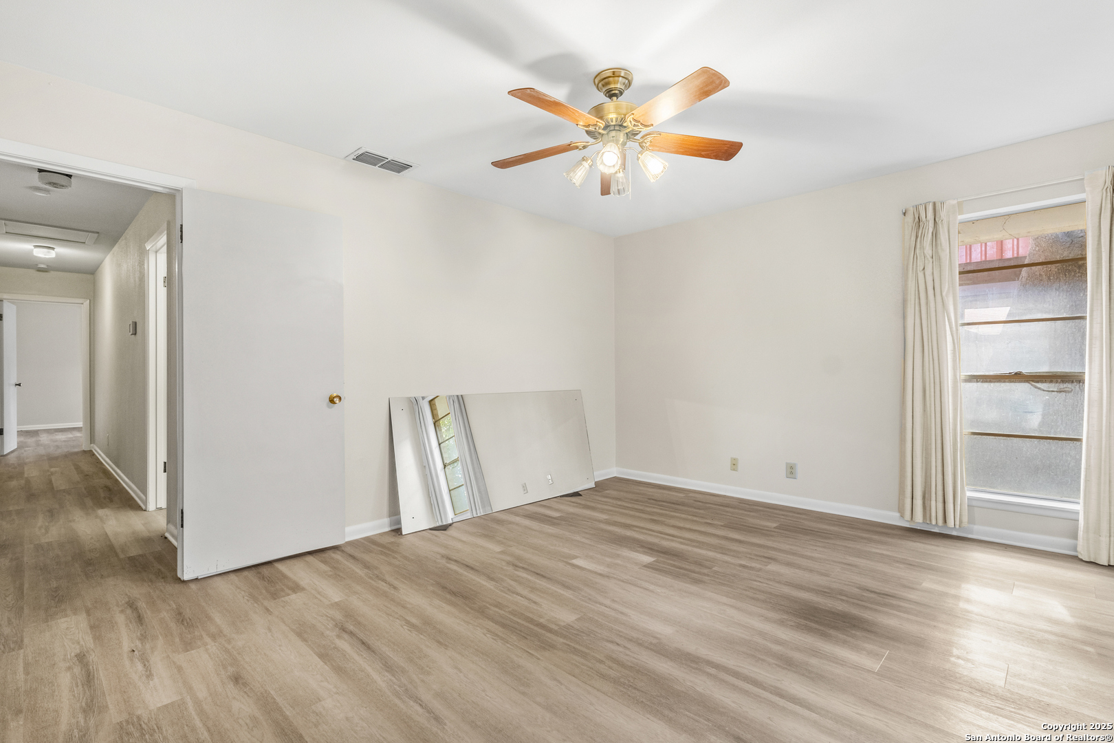 6041 Trone Trail Leon Valley, TX 78238 - Photo 22 of 30 wooden floor in an empty room with a window