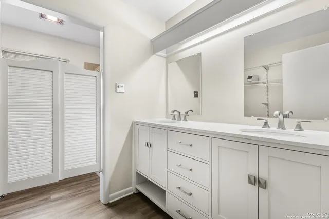 a bathroom with double sink and a mirror