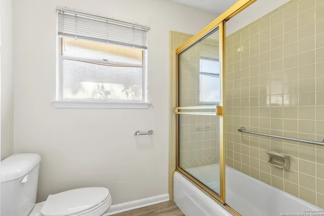 a bathroom with a toilet and a shower