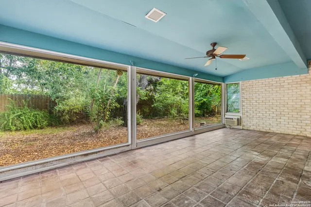 a view of room with window and ceiling fan