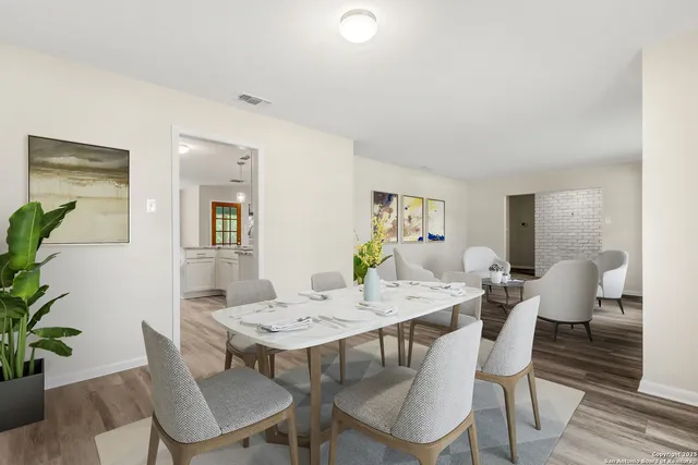 a view of a dining room with furniture and wooden floor