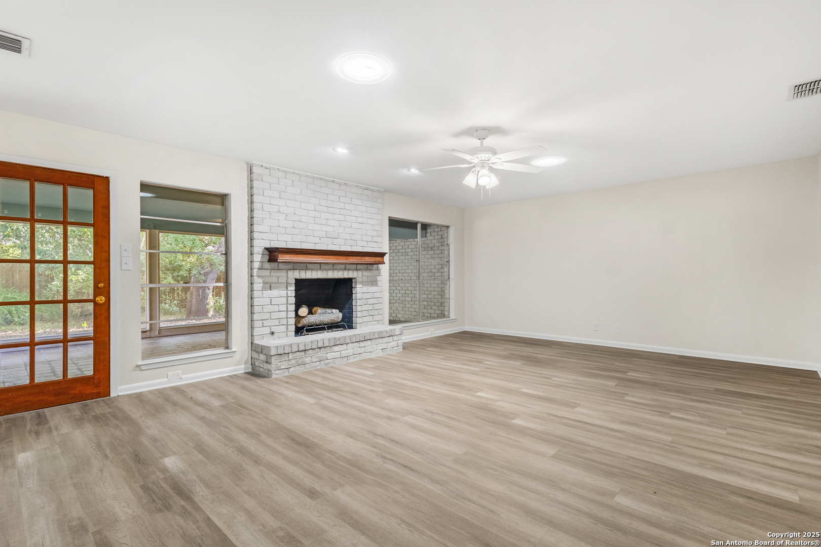6041 Trone Trail Leon Valley, TX 78238 - Photo 10 of 30 an empty room with windows and fireplace