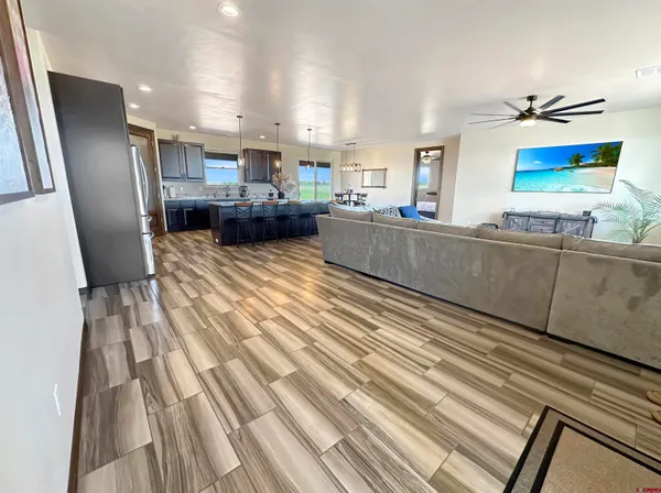 a kitchen with stainless steel appliances kitchen island granite countertop a refrigerator and microwave