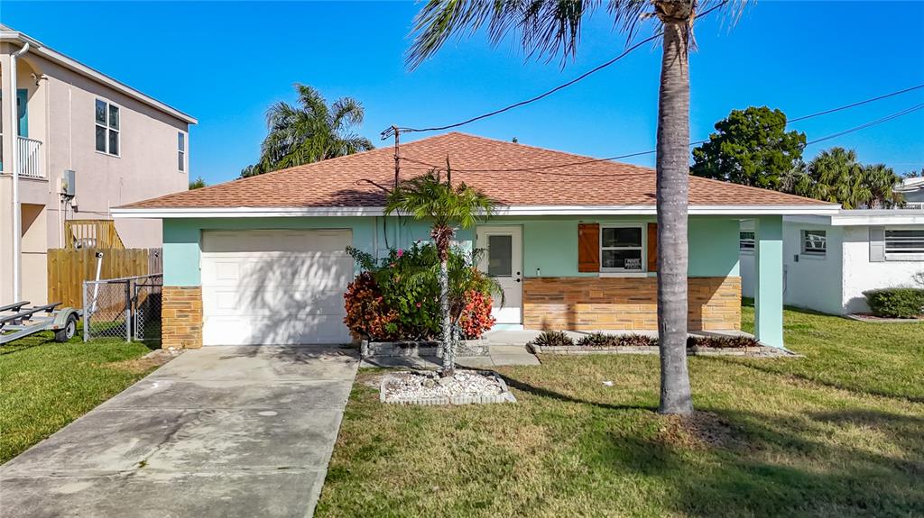 7027 McCray Drive Hudson, FL 34667 - Photo 1 of 33 a view of a house with a yard and plants