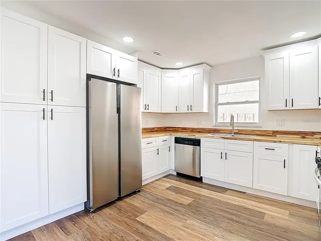 a kitchen with granite countertop appliances cabinets and a sink