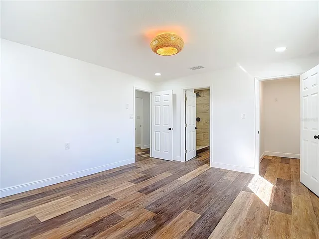 a view of an empty room and wooden floor