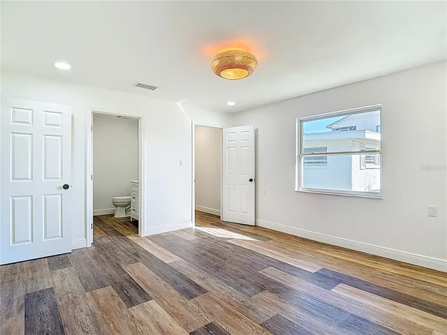 a view of an empty room and wooden floor