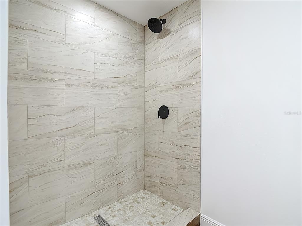 7027 McCray Drive Hudson, FL 34667 - Photo 21 of 33 a bathroom with a shower