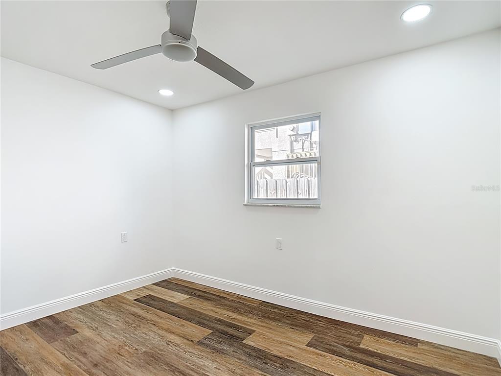 7027 McCray Drive Hudson, FL 34667 - Photo 24 of 33 an empty room with wooden floor and windows