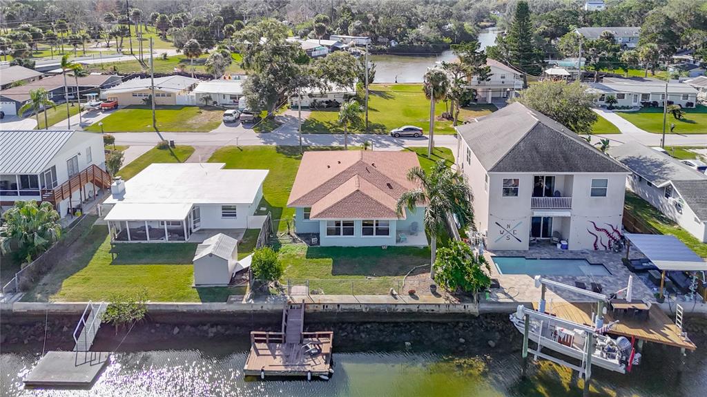 7027 McCray Drive Hudson, FL 34667 - Photo 31 of 33 an aerial view of a house with swimming pool and tennis court