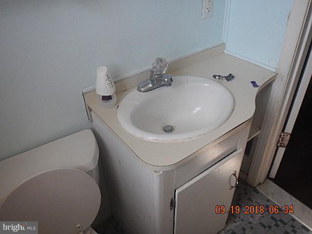1635 Riverwood Road Baltimore, MD 21221 - Photo 12 of 30 a bathroom with a sink and toilet