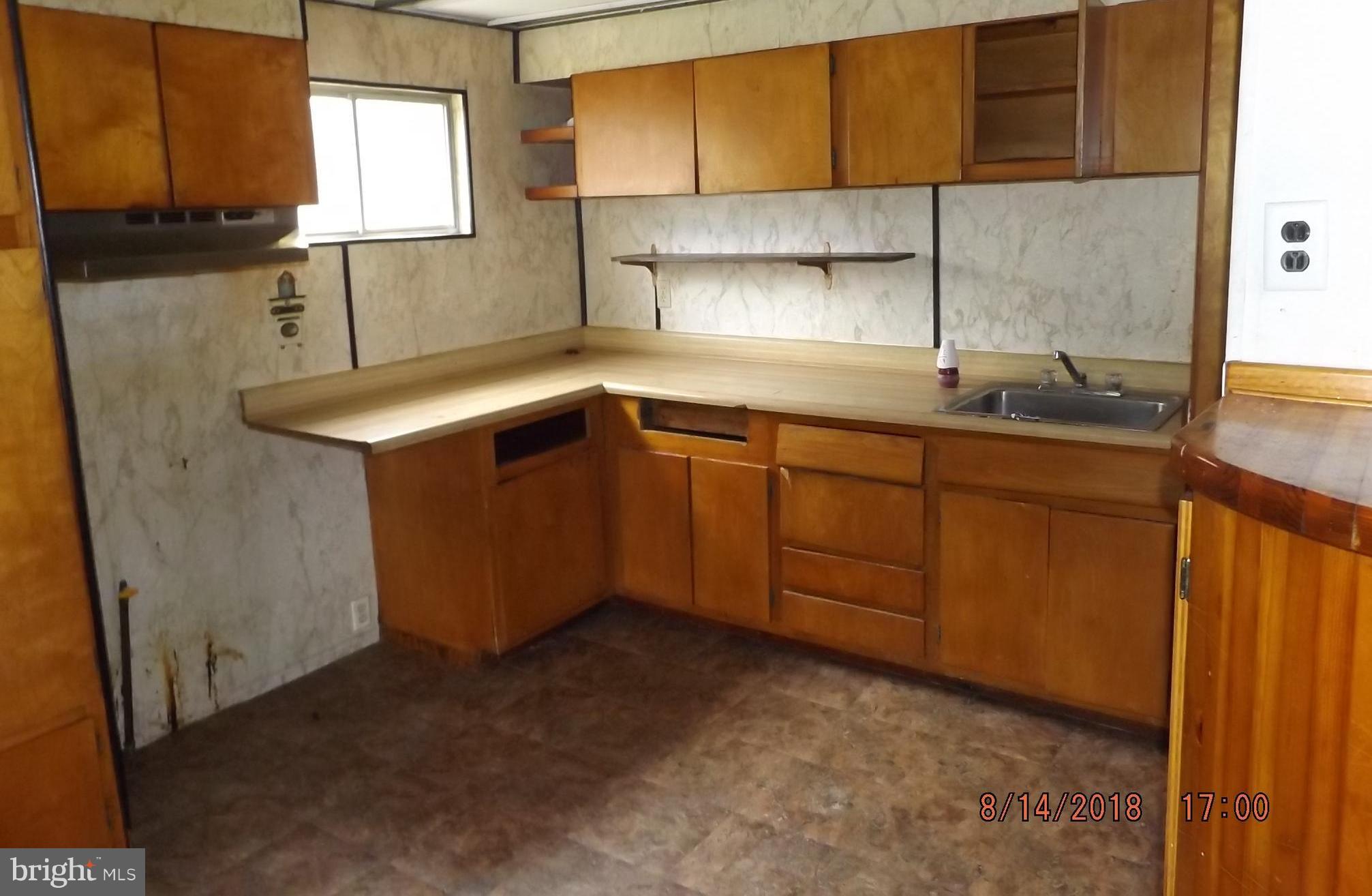 1635 Riverwood Road Baltimore, MD 21221 - Photo 25 of 30 a kitchen with a sink cabinets and window