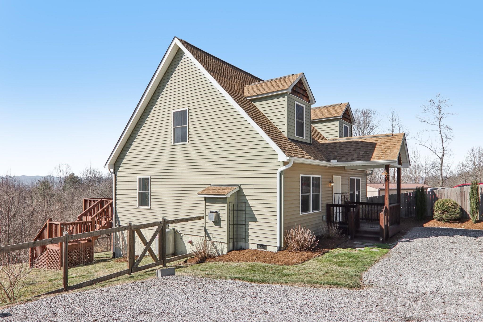 751 Hutch Mountain Road Fletcher, NC 28732 - Photo 5 of 48 a view of a house with a yard and furniture