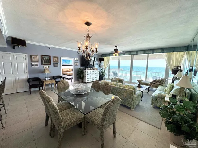 a view of a dining room with furniture and a chandelier