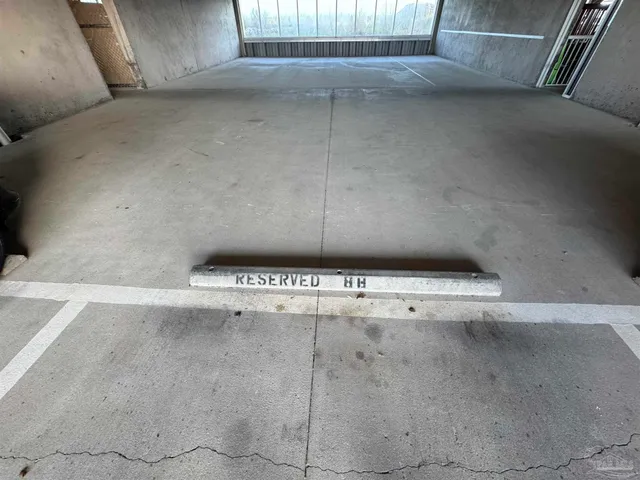 a living room with patio furniture and a chandelier