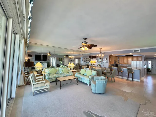 a living room with lots of furniture and a chandelier