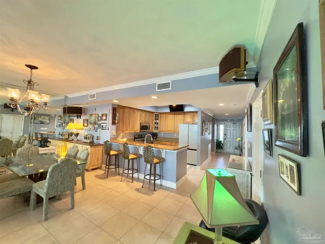 a living room with lots of furniture and a chandelier