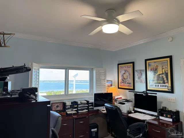 a view of a workspace with furniture and a window