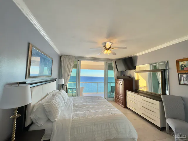 a bedroom with a large bed and a tv